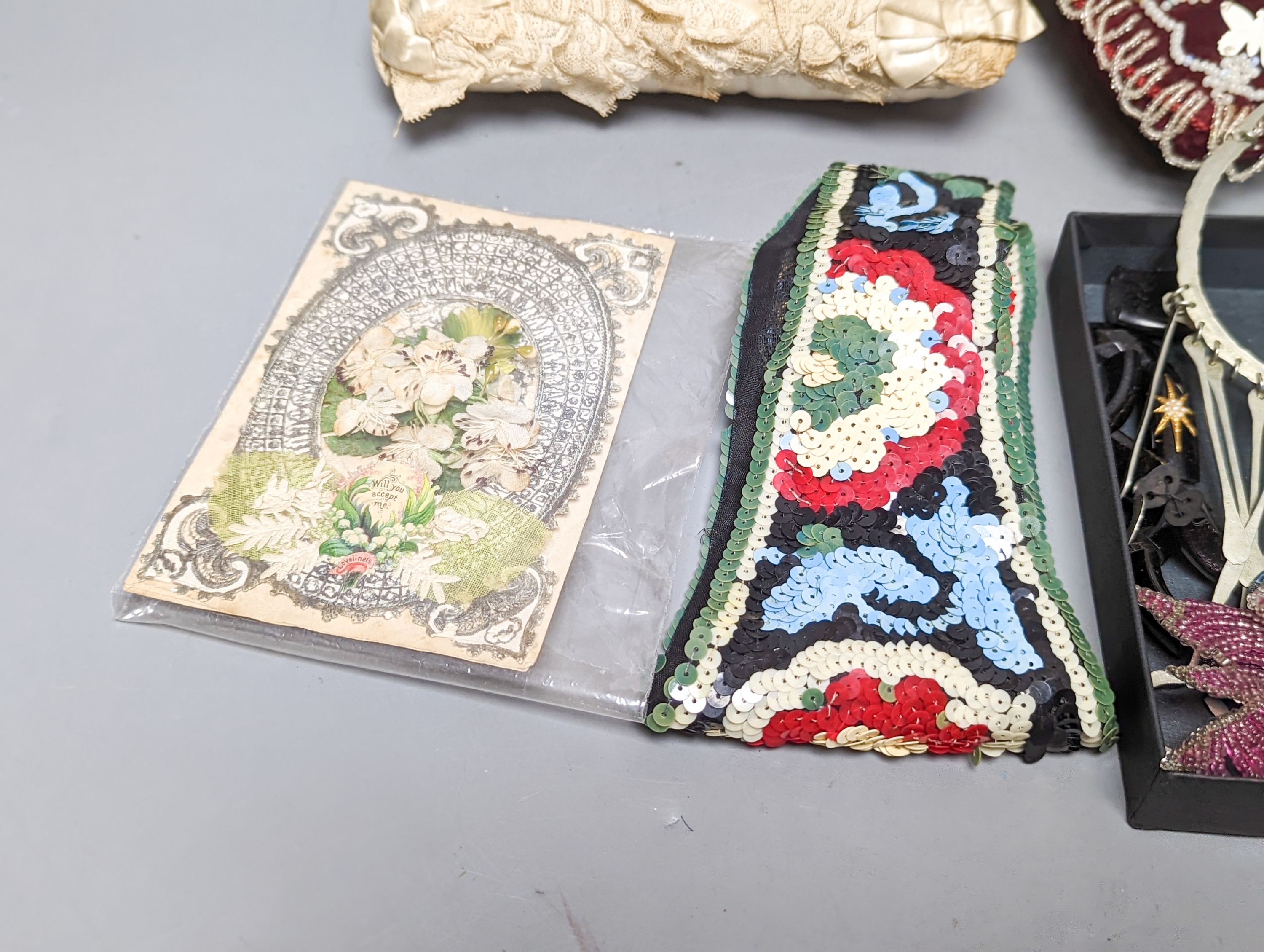 A cream silk pin baby cushion, a valentine cushion, a miser's purse, appliques and sequin collar